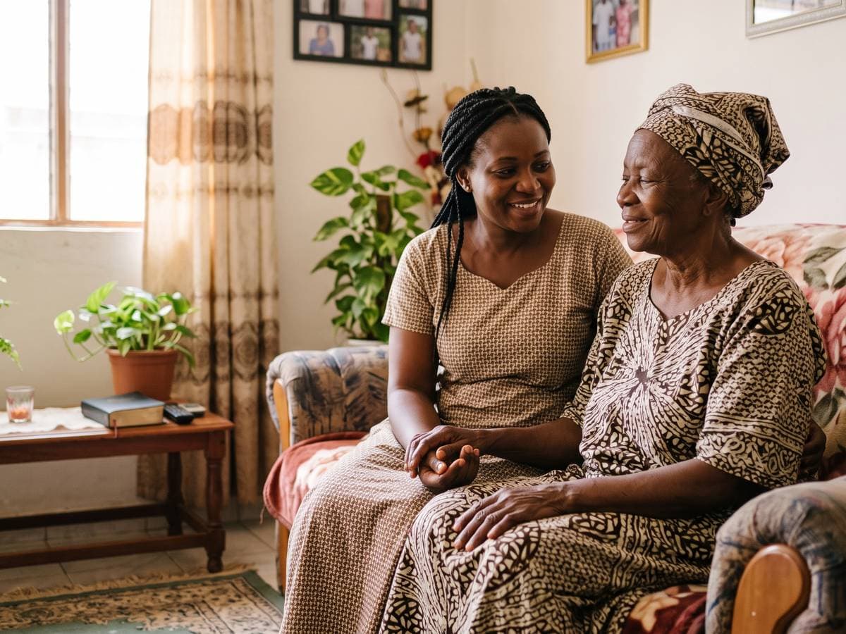 A family member spending a warm moment with her elderly mother at home